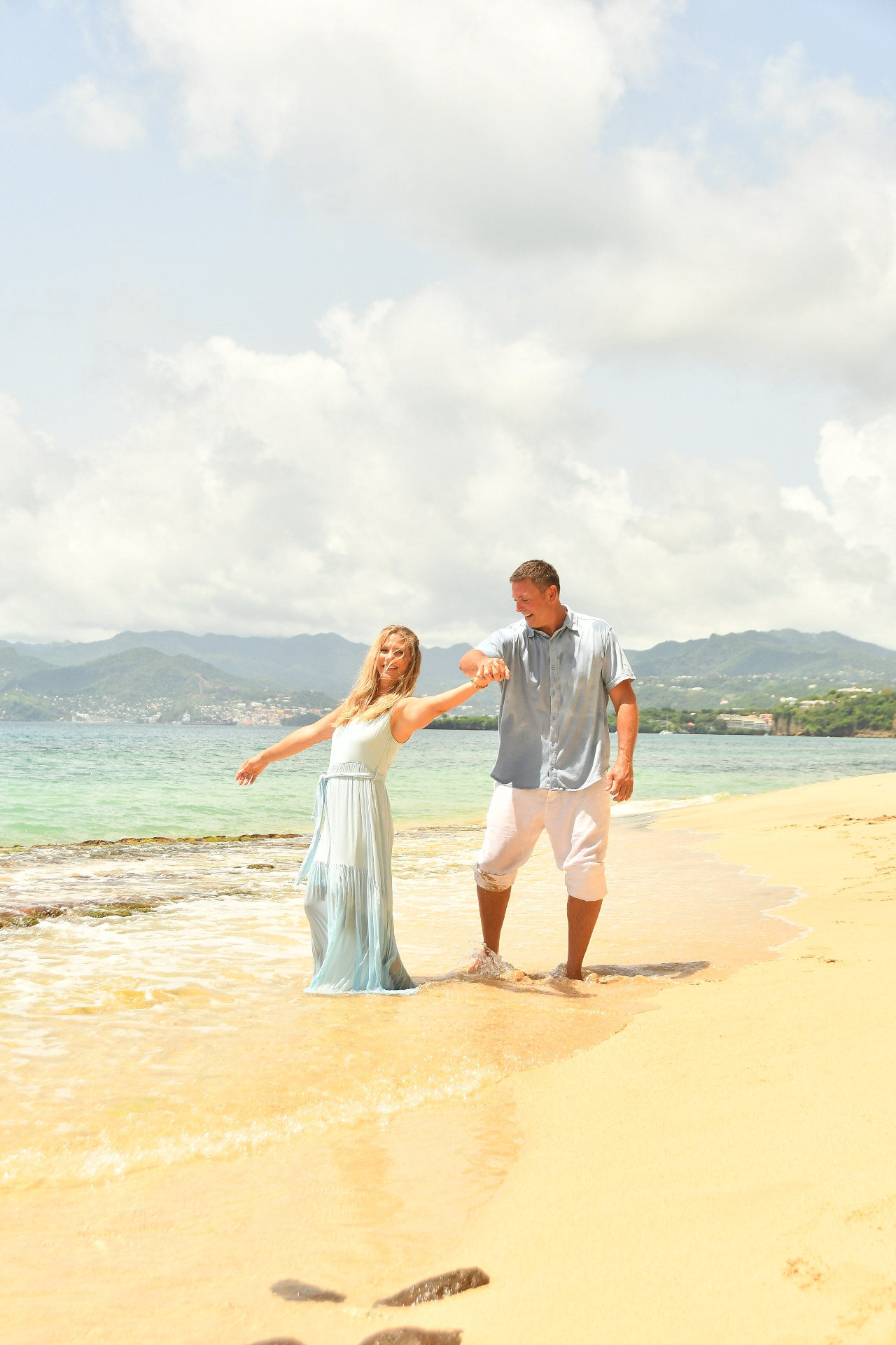 Chris and Anastasia Bray, stewards of Free Holler Farm, walking along the shoreline